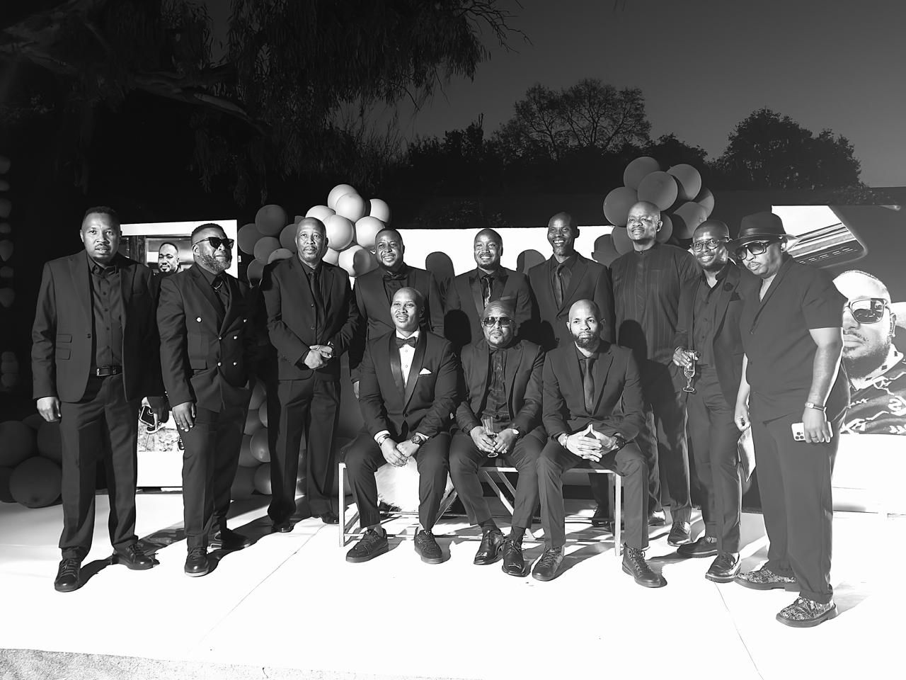 Alpha Team members dressed in formal suits at an evening event
