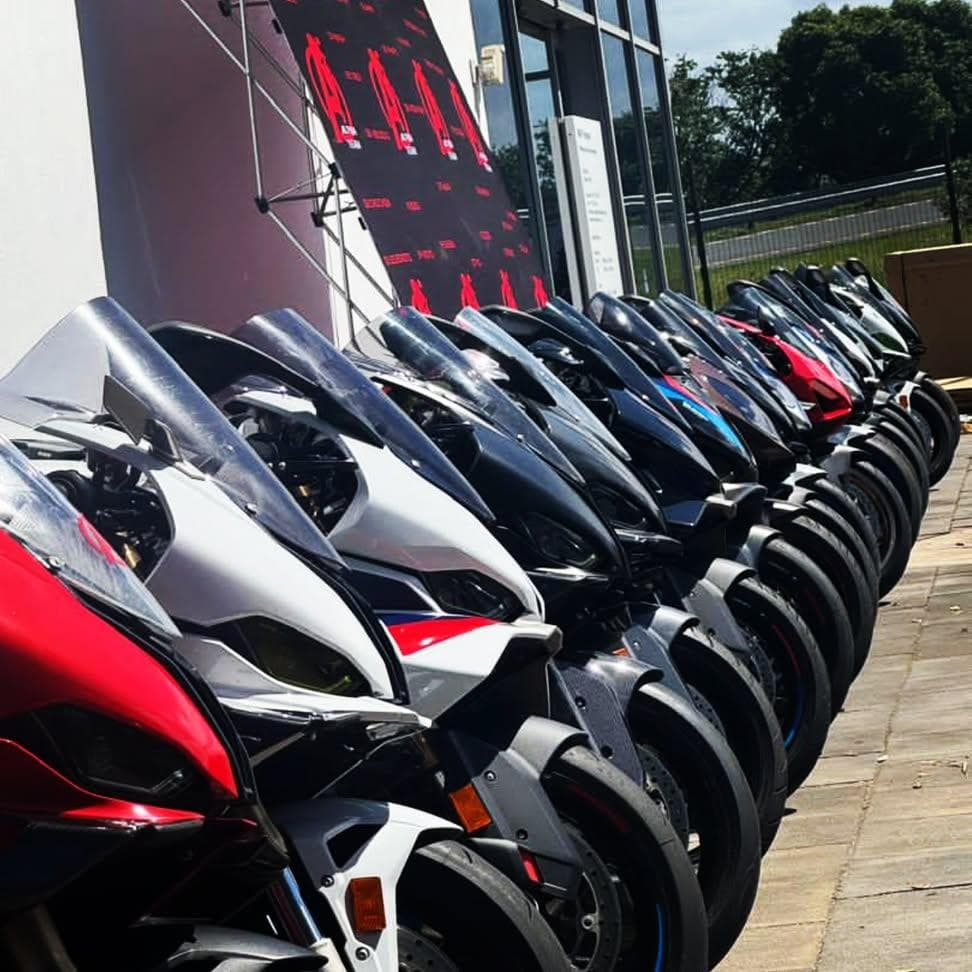 Row of BMW S1000RR and Ducati superbikes lined up outside a dealership